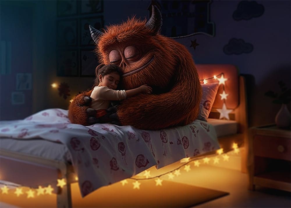 A child hugging a friendly imaginary monster in a softly lit bedroom